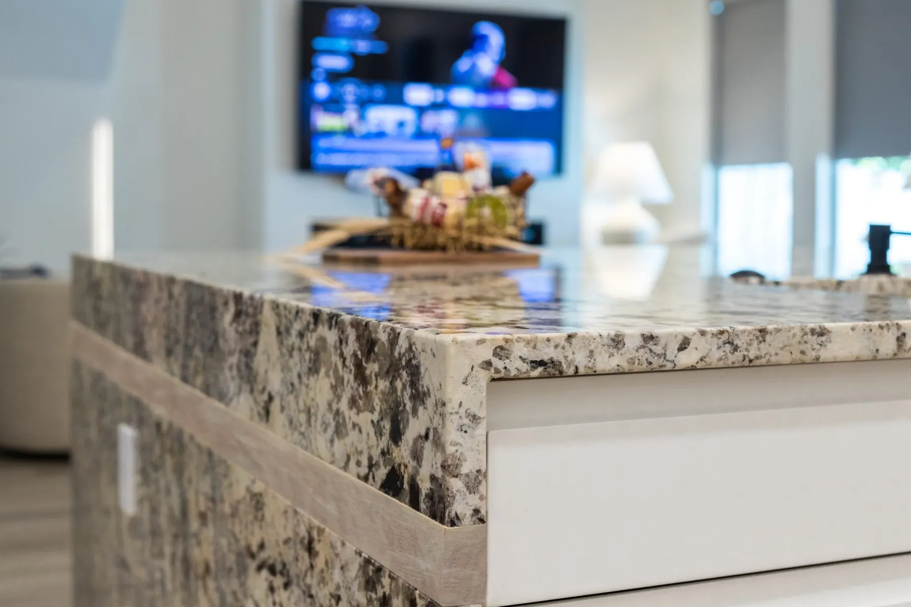 Granite waterfall island edge with a light wood trim band, Bee Cave kitchen by ATX Renovations